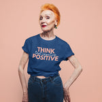 Think Positive Test Negative Blue T Shirt on older woman red hair studio shot