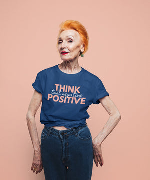 Think Positive Test Negative Blue T Shirt on older woman red hair studio shot